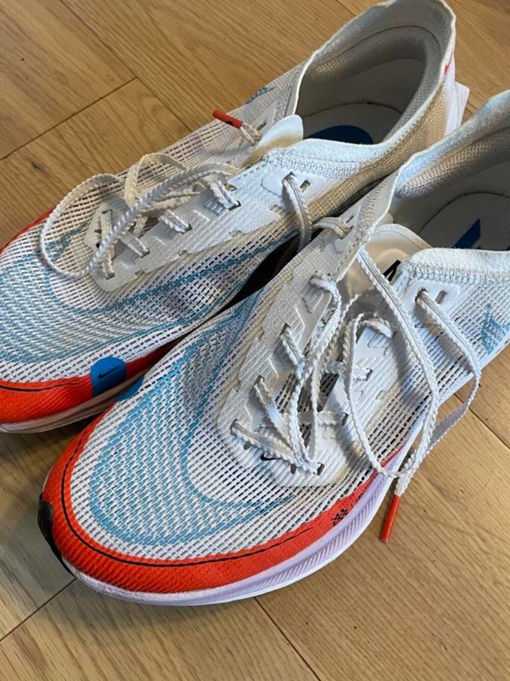 Nike Vaporfly 4% white, blue, and orange running shoes #running #vaporfly